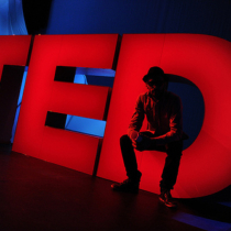 TED Prize winner JR meets the oversized onstage TED logo. Behind the scenes at TED2011, February 28 - March 4, Long Beach, CA. Credit: James Duncan Davidson / TED